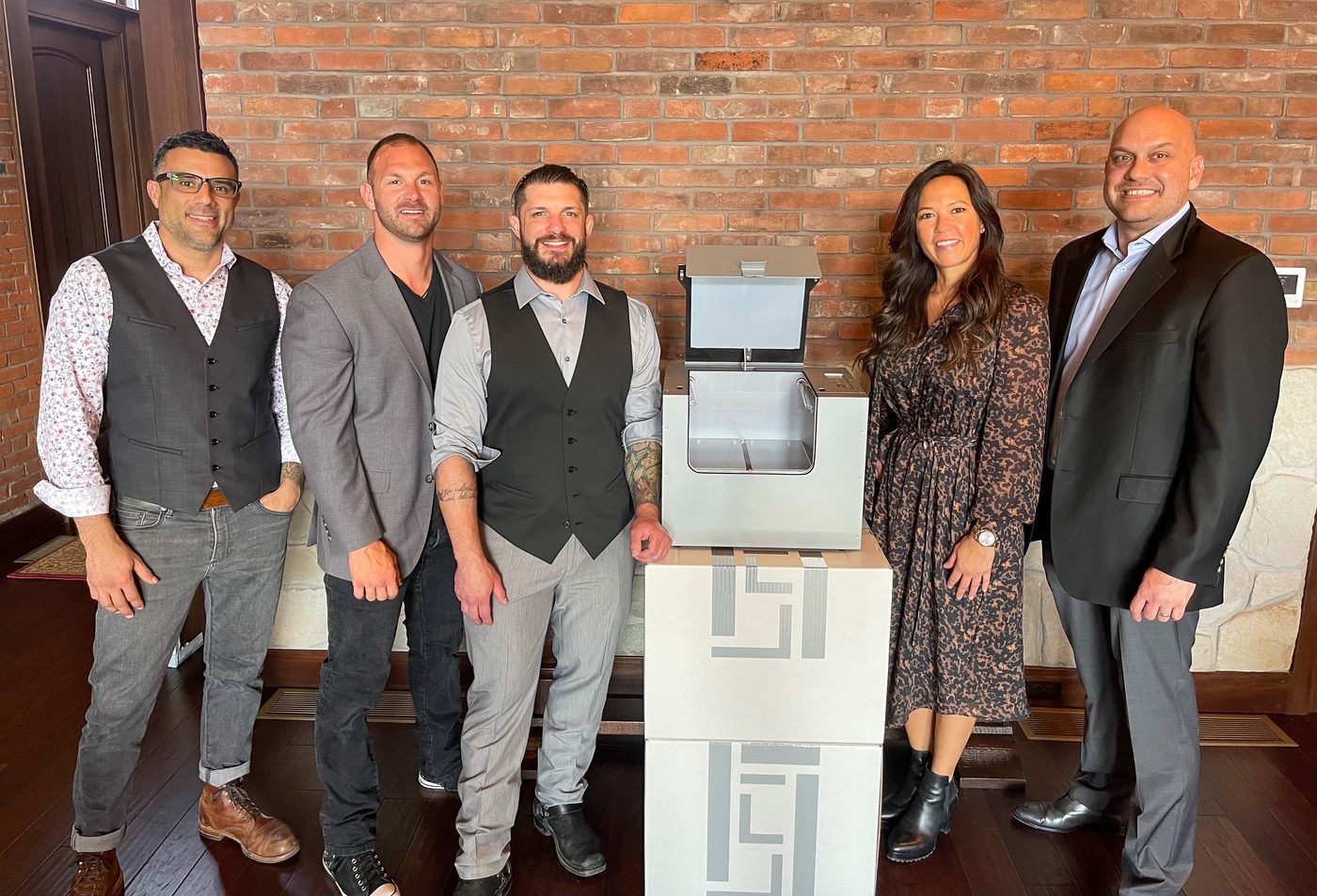 The Forge team standing with the validation-ready RLX MK1 sterilizer